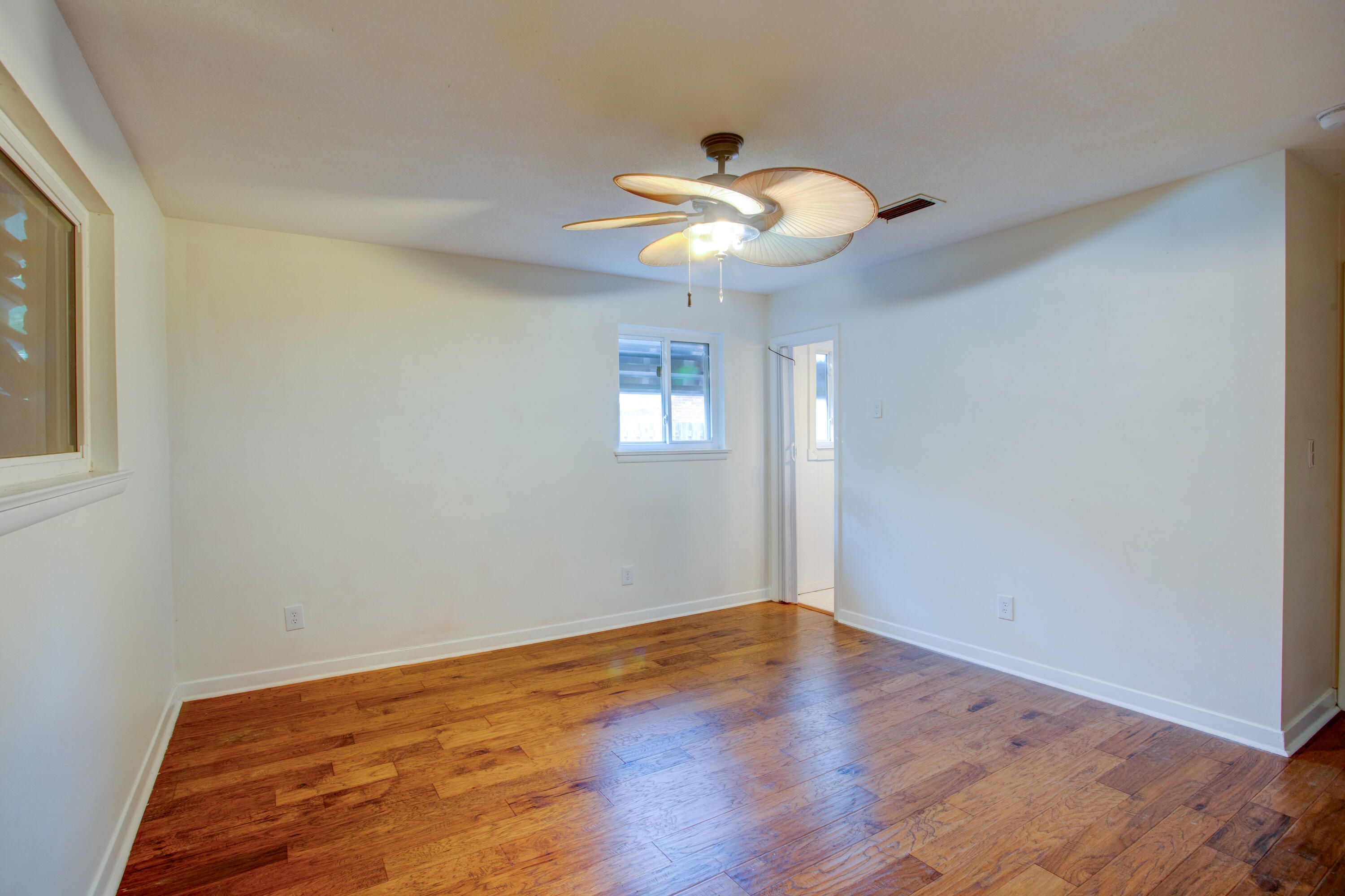 60 Linwood Road Northwest Fort Walton Beach, FL 32547 - Photo 12 of 14 a view of an empty room with wooden floor and a window