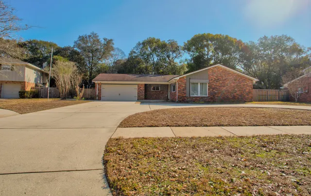 a front view of a house with a garden and yard