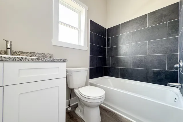 a bathroom with a sink a toilet and bathtub