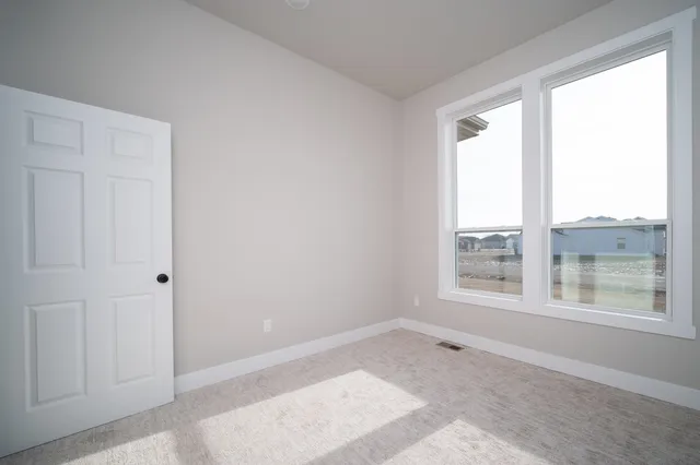 a view of an empty room and a window