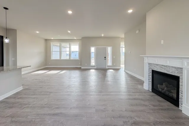 a view of an empty room with fireplace and a window
