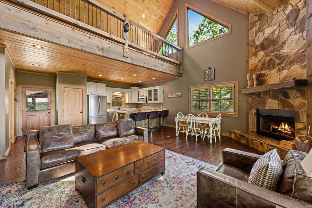 479 Big Timber Road Mineral Bluff, GA 30559 - Photo 8 of 60 a living room with furniture a fireplace and a table