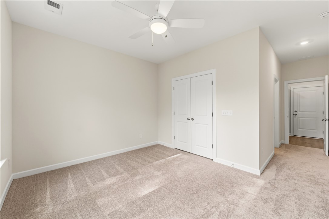 1108 Manse Jolly Road Anderson, SC 29621 - Photo 22 of 45 This spacious room features soft carpet, a ceiling fan, and ample closet space.