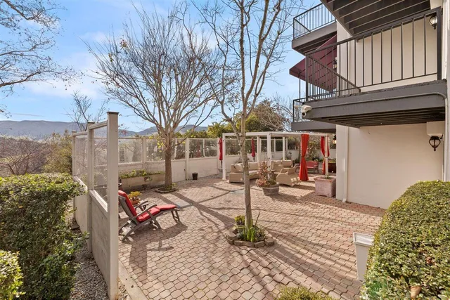 a backyard of a house with table and chairs
