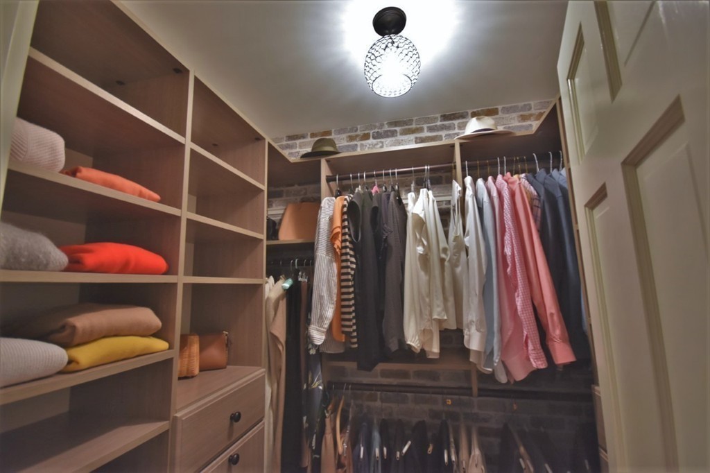 6 Atlantic View, Unit 6 Amesbury, MA 01913 - Photo 17 of 42 a view of walk in closet with clothes and shoes