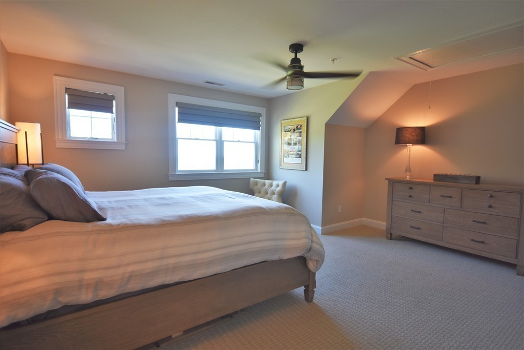 6 Atlantic View, Unit 6 Amesbury, MA 01913 - Photo 25 of 42 a spacious bedroom with a bed and a dresser