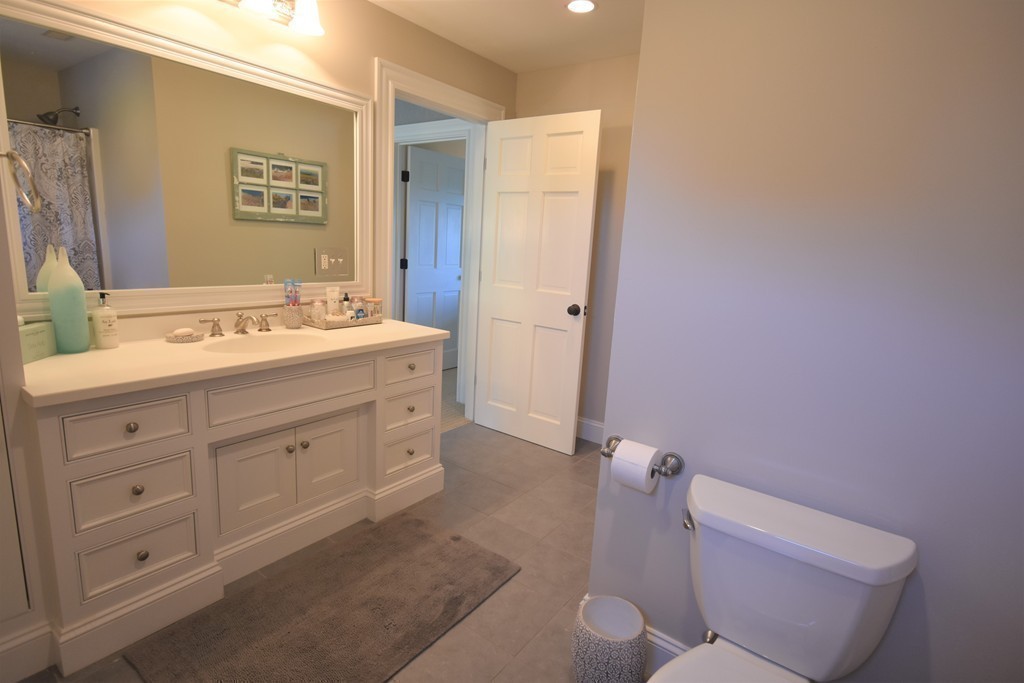 6 Atlantic View, Unit 6 Amesbury, MA 01913 - Photo 26 of 42 a spacious bathroom with a double vanity sink a toilet and a mirror