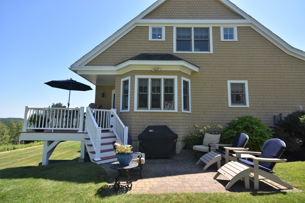 6 Atlantic View, Unit 6 Amesbury, MA 01913 - Photo 37 of 42 a front view of a house with garden and chairs