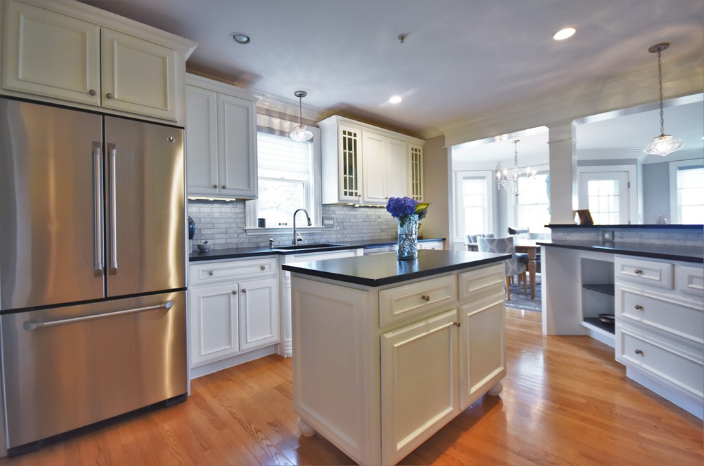 6 Atlantic View, Unit 6 Amesbury, MA 01913 - Photo 4 of 42 a kitchen with stainless steel appliances granite countertop a refrigerator a sink dishwasher a stove and white cabinets with wooden floor