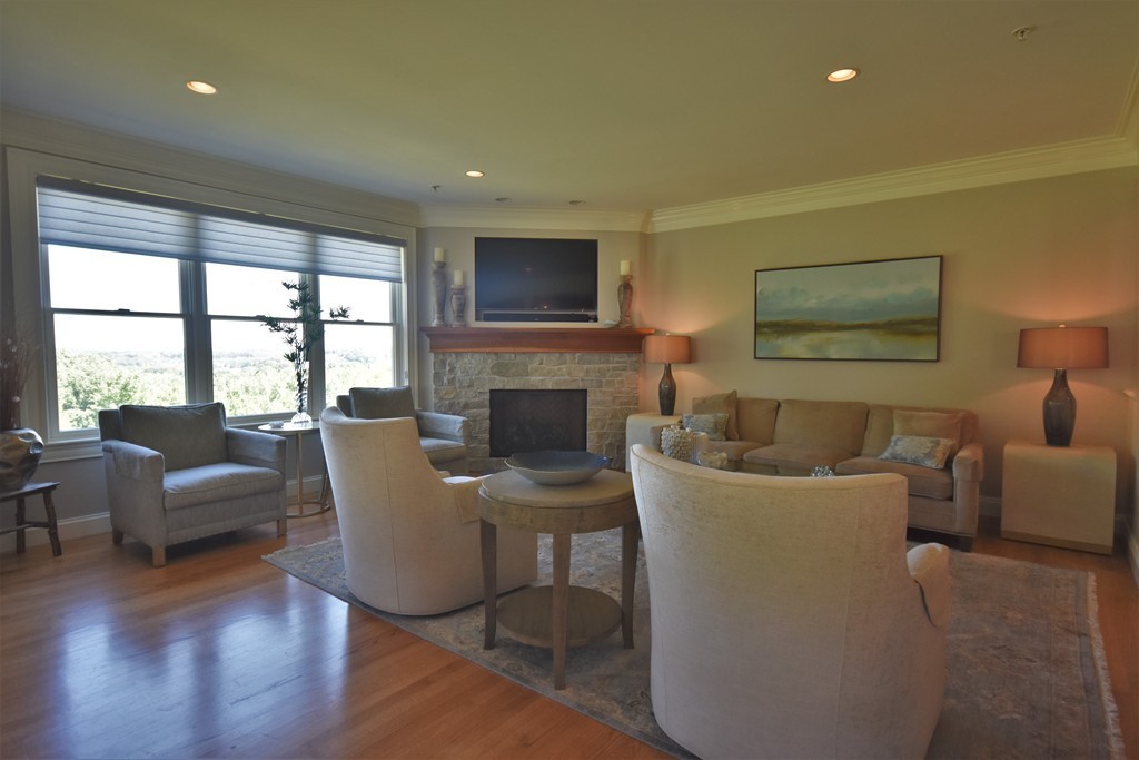 6 Atlantic View, Unit 6 Amesbury, MA 01913 - Photo 8 of 42 a living room with fireplace furniture and a large window