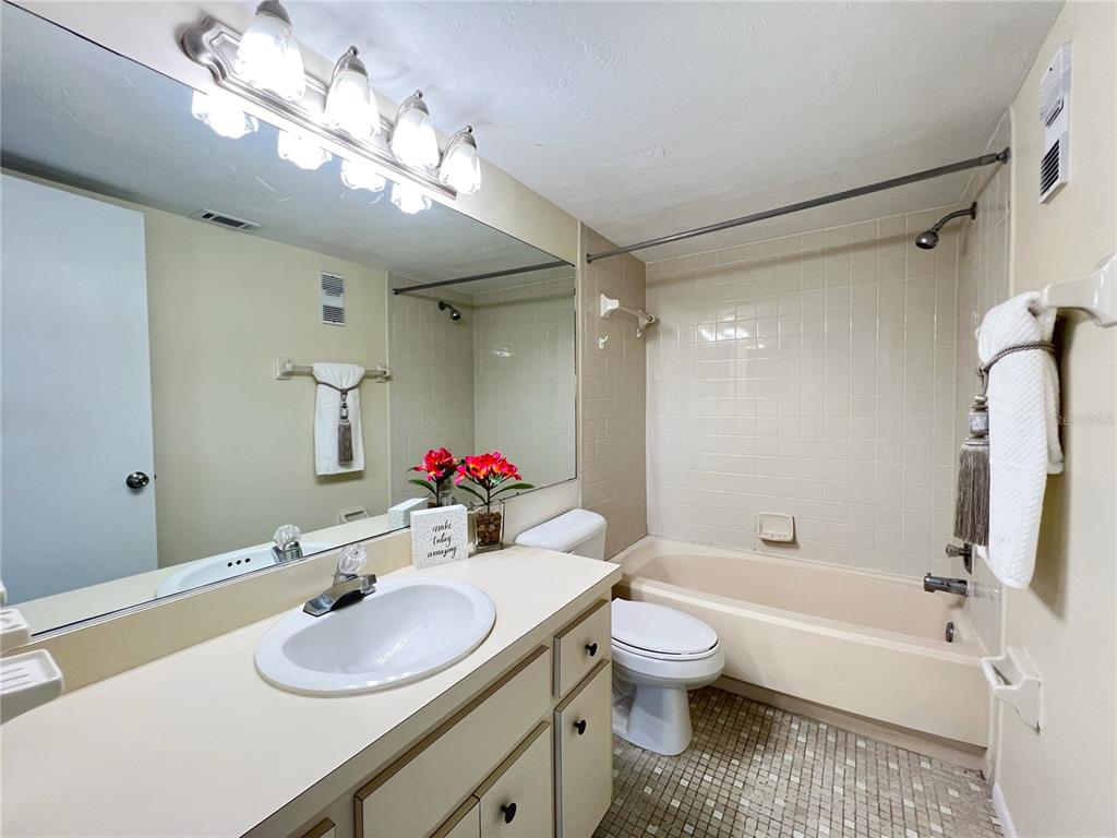3233 Candle Ridge Drive, Unit 101 Orlando, FL 32822 - Photo 11 of 24 a bathroom with a sink vanity granite toilet tub and shower