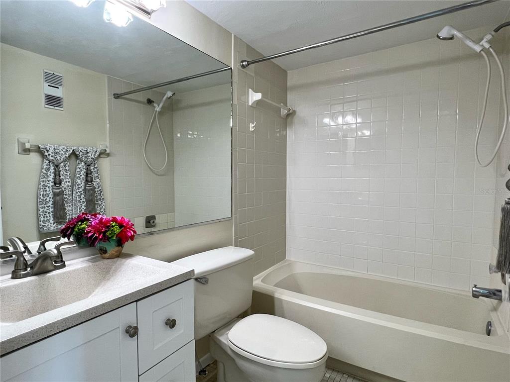 3233 Candle Ridge Drive, Unit 101 Orlando, FL 32822 - Photo 14 of 24 a bathroom with a sink a toilet and shower