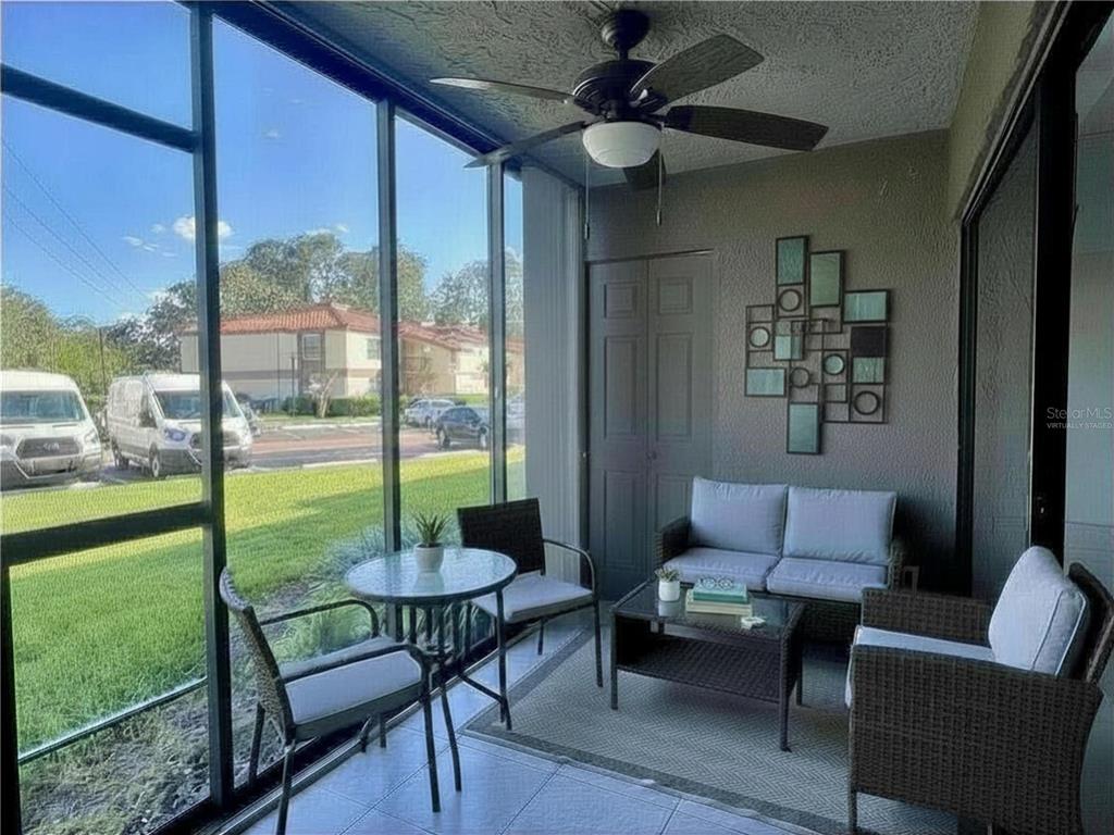 3233 Candle Ridge Drive, Unit 101 Orlando, FL 32822 - Photo 15 of 24 a living room with furniture and a floor to ceiling window