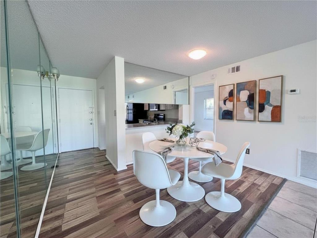 3233 Candle Ridge Drive, Unit 101 Orlando, FL 32822 - Photo 3 of 24 a living room with furniture and a wooden floor