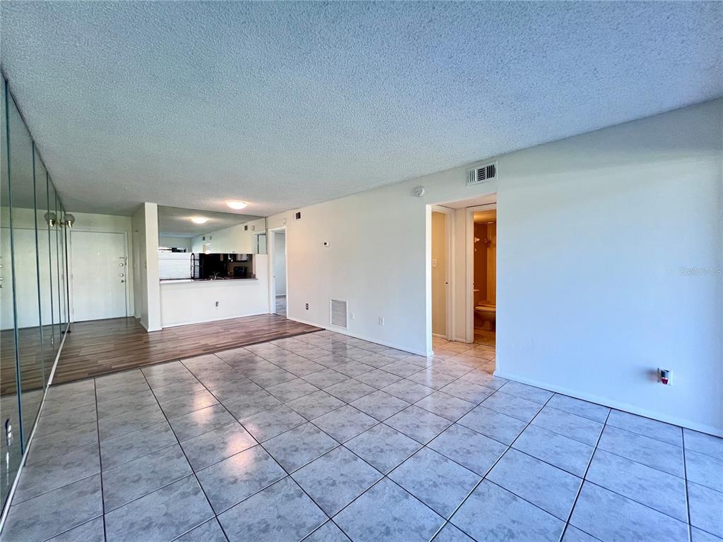 3233 Candle Ridge Drive, Unit 101 Orlando, FL 32822 - Photo 6 of 24 a view of a hallway with wooden floor and a cabinet