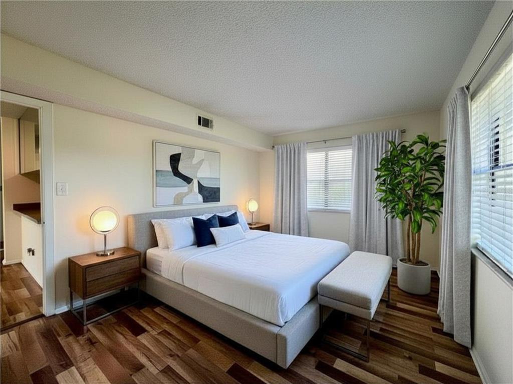 3233 Candle Ridge Drive, Unit 101 Orlando, FL 32822 - Photo 9 of 24 a bedroom with a bed and a potted plant