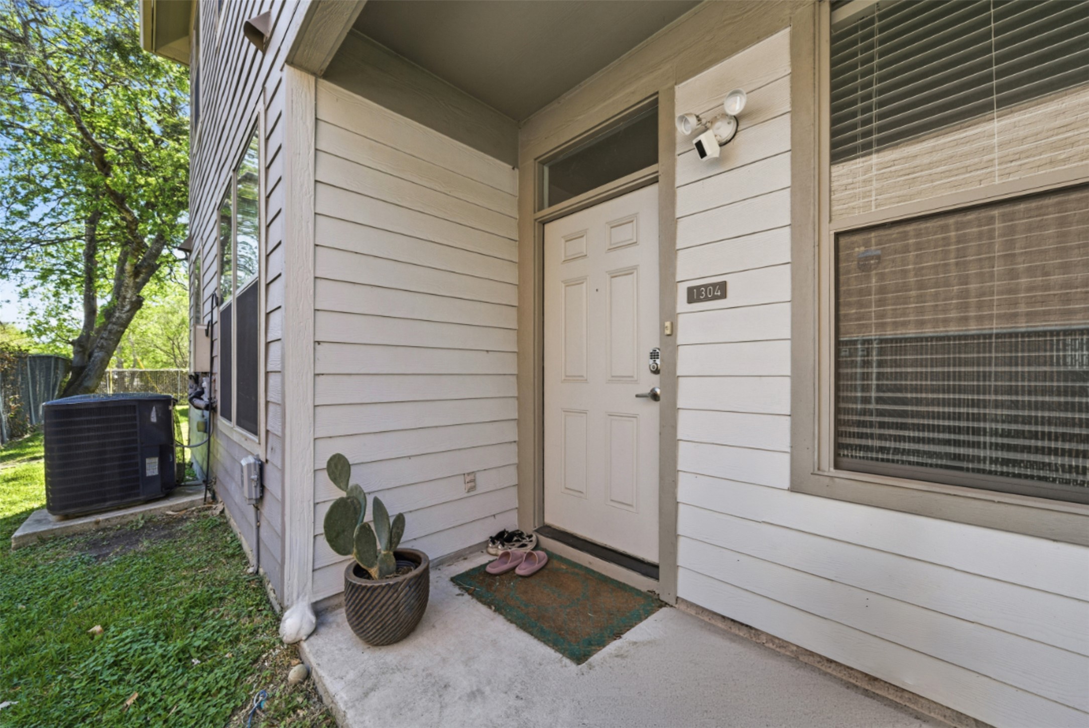 1201 Grove Boulevard, Unit 1304 Austin, TX 78741 - Photo 4 of 19 a view of front door and potted plants
