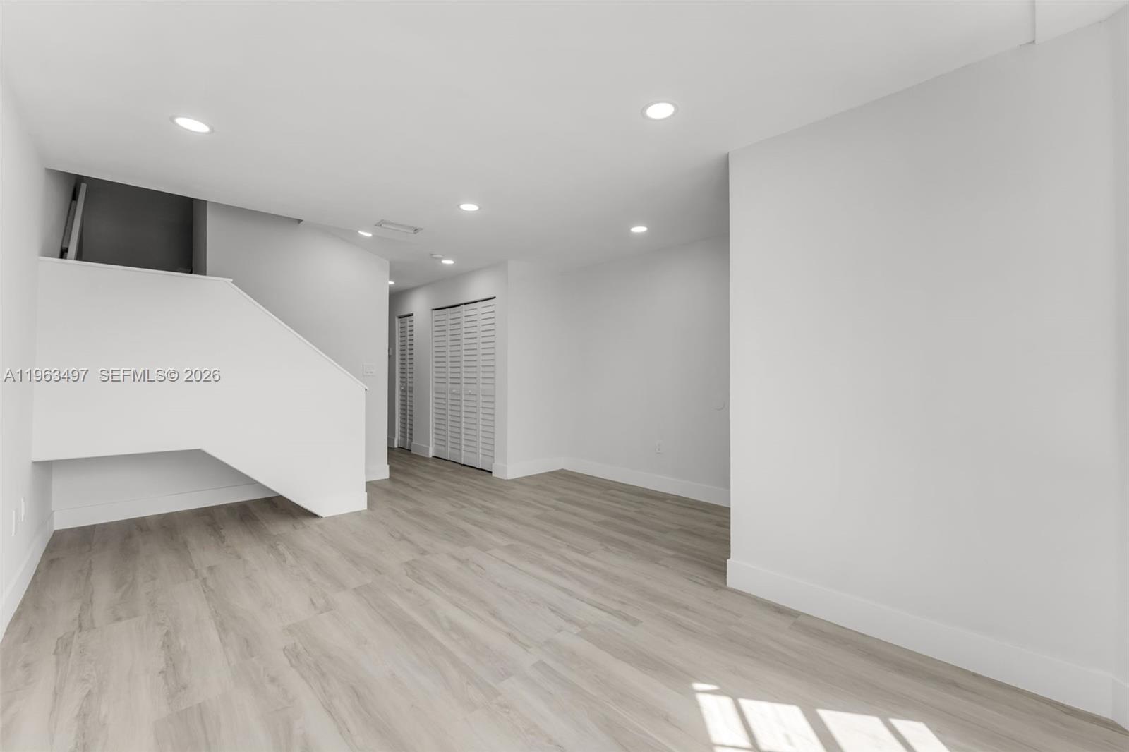 15430 Southwest 74th Cir Court Miami, FL 33193 - Photo 4 of 38 a view of an empty room with wooden floor