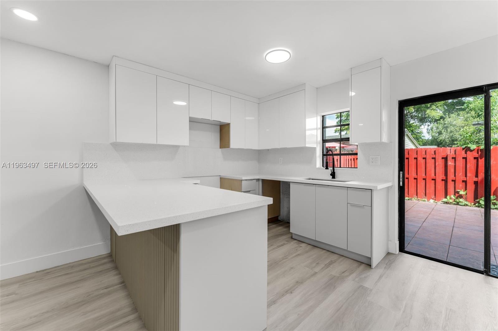 15430 Southwest 74th Cir Court Miami, FL 33193 - Photo 9 of 38 a kitchen with a sink window and cabinets