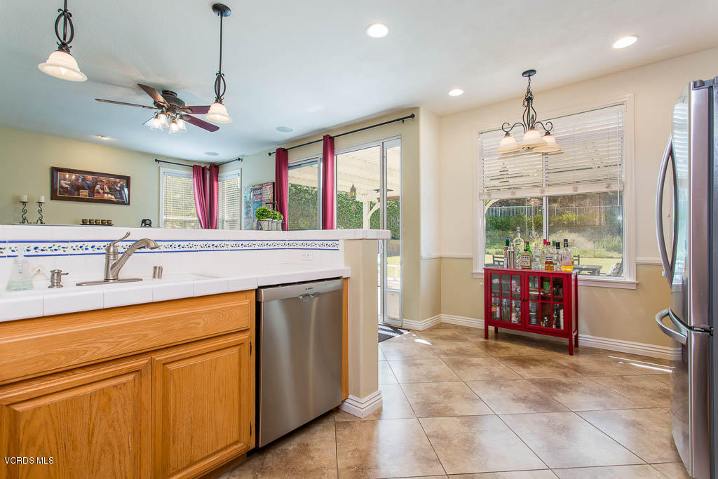 3877 Sunsetridge Road Moorpark, CA 93021 - Photo 12 of 30 a open kitchen with stainless steel appliances granite countertop a refrigerator and a sink