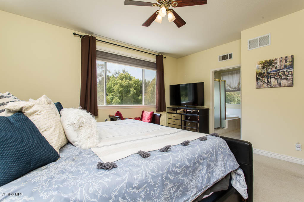 3877 Sunsetridge Road Moorpark, CA 93021 - Photo 15 of 30 a bedroom with a bed and a flat screen tv