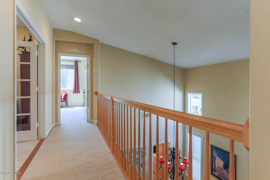 3877 Sunsetridge Road Moorpark, CA 93021 - Photo 17 of 30 a view of a hallway with wooden floor and staircase