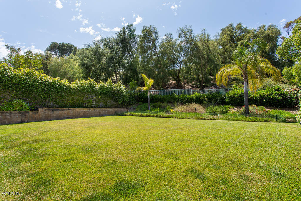 3877 Sunsetridge Road Moorpark, CA 93021 - Photo 28 of 30 a view of a swimming pool and trees in the background