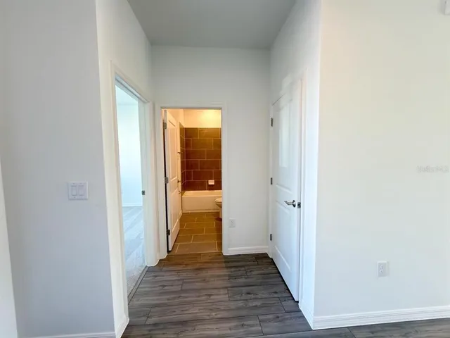 a view of a hallway with wooden floor
