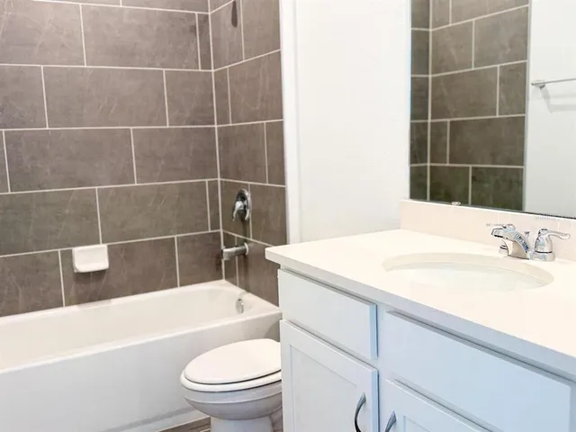 a spacious bathroom with a double vanity sink and a mirror