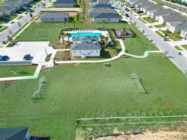 a view of a room with wooden floor staircase and a kitchen