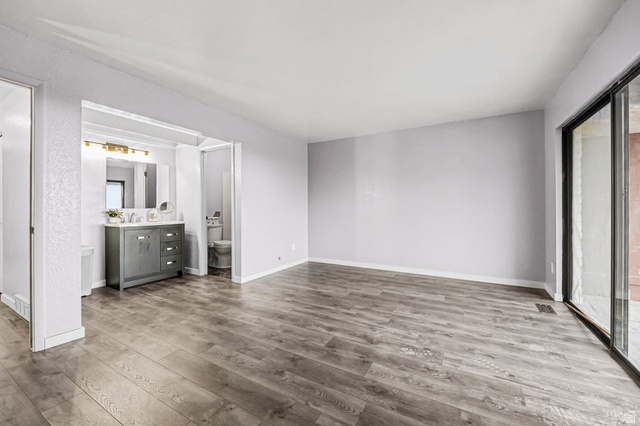 34 Benchmark Village Tooele, UT 84074 - Photo 14 of 35 Unfurnished bedroom with access to exterior and wood finished floors