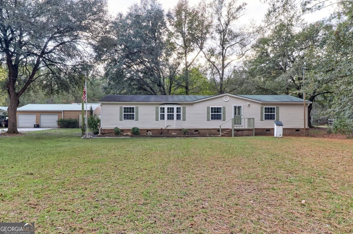 287 Sagepointe Road Guyton, GA 31312 - Photo 1 of 1 a front view of a house with a garden