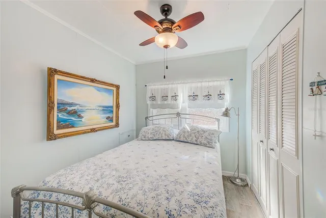 a bedroom with a large bed and a chandelier