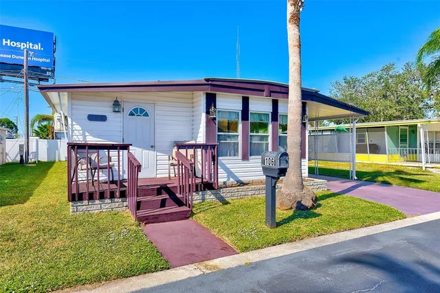 a view of a house with a swimming pool and a yard