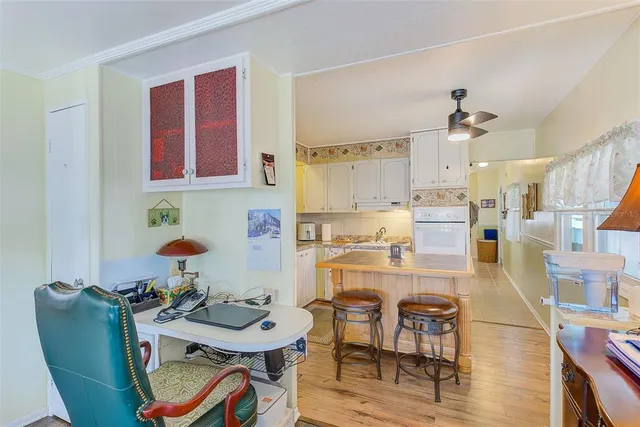 a room with stainless steel appliances kitchen island dining table and chairs