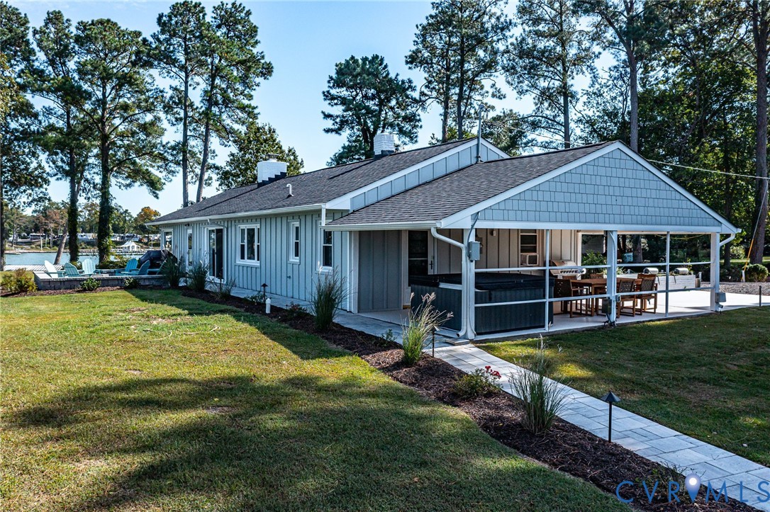 560 Eubank Landing Road Topping, VA 23169 - Photo 17 of 50 a view of a house with a yard patio and swimming pool