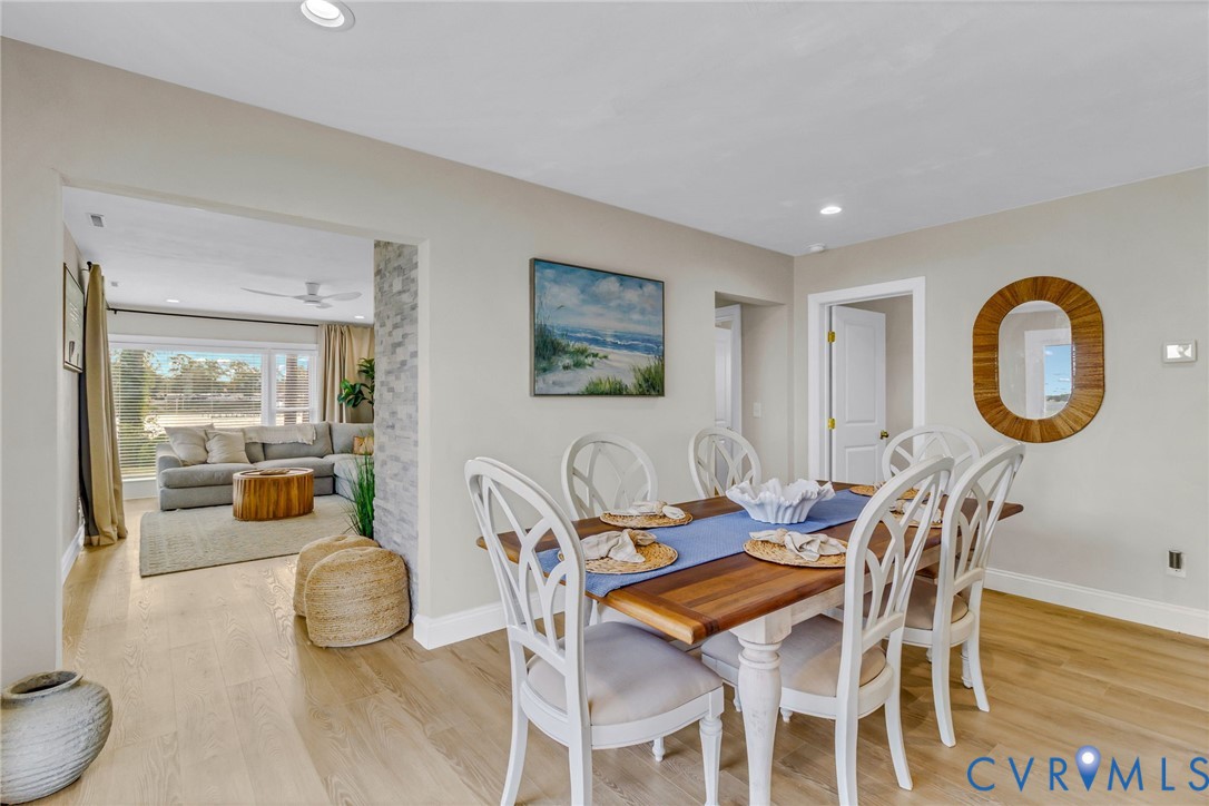 560 Eubank Landing Road Topping, VA 23169 - Photo 24 of 50 a dining room with furniture and wooden floor