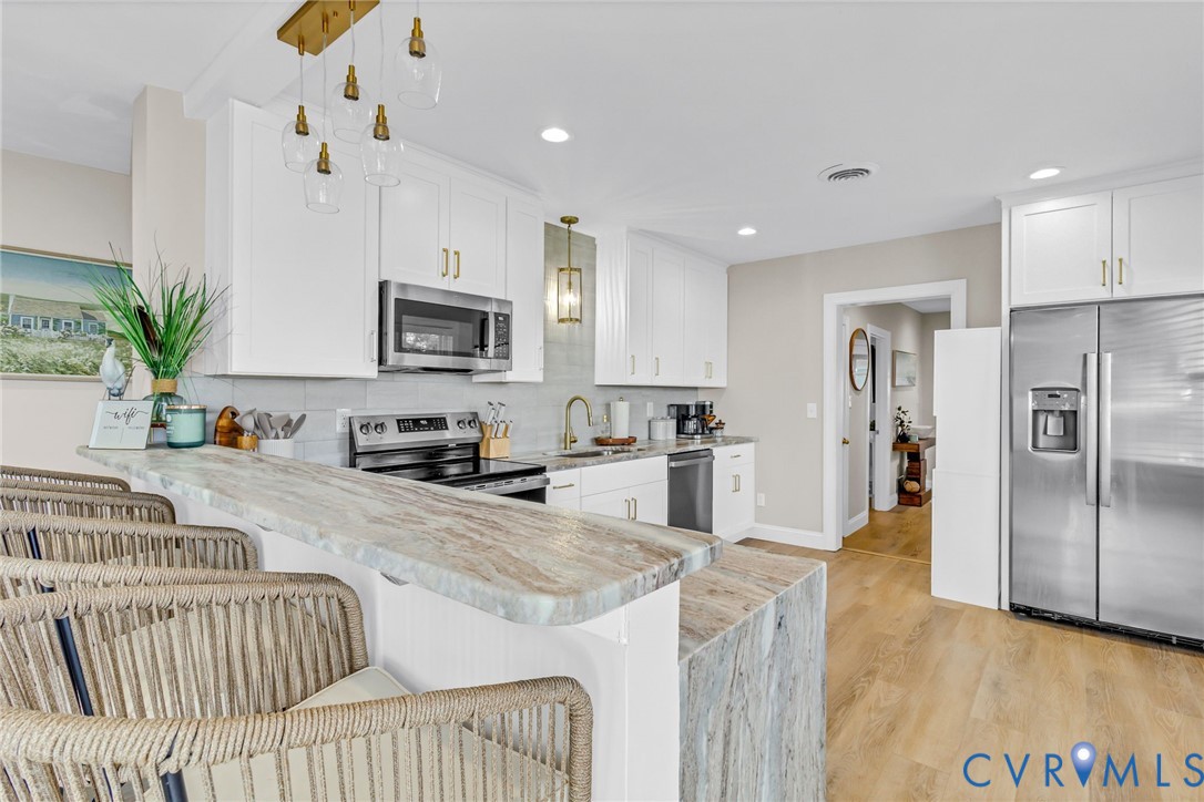 560 Eubank Landing Road Topping, VA 23169 - Photo 26 of 50 a kitchen with granite countertop lots of counter top space appliances and cabinets