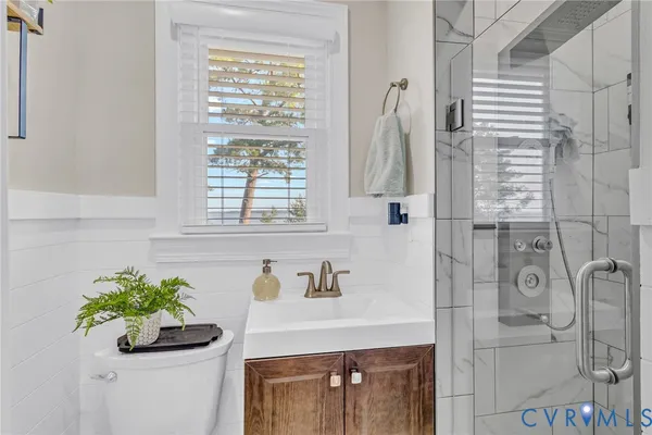 a bathroom with a sink a mirror and a shower