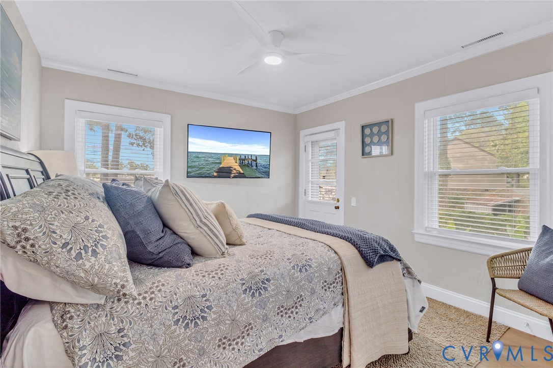 560 Eubank Landing Road Topping, VA 23169 - Photo 32 of 50 a bedroom with a large bed and a window