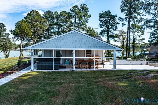a view of a house with a yard and sitting area