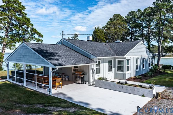 a view of a house with backyard and sitting area