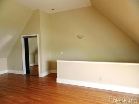 304 Chateau Rive, Unit 304 Peekskill, NY 10566 - Photo 9 of 15 Additional living space with vaulted ceiling and dark hardwood / wood-style floors