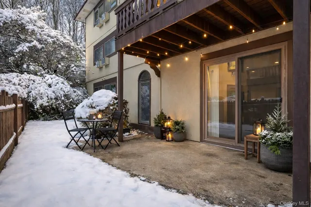 a view of a patio with a table and chairs and potted plants