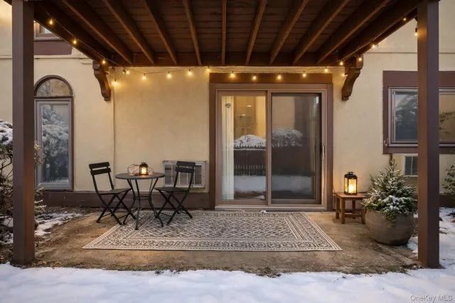 a view of a porch with dining table and chairs