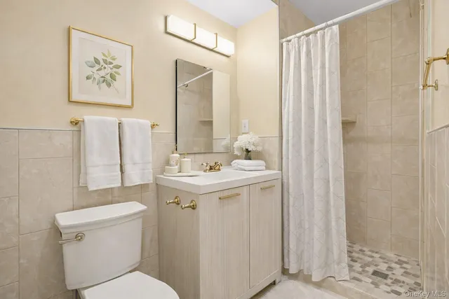 a bathroom with a sink a toilet and shower curtain