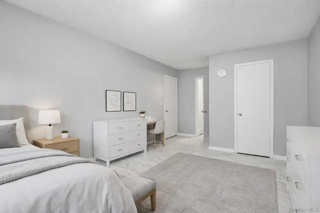 a bedroom with a bed and dresser