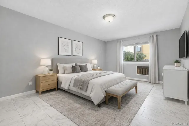 a spacious bedroom with a bed and a flat screen tv