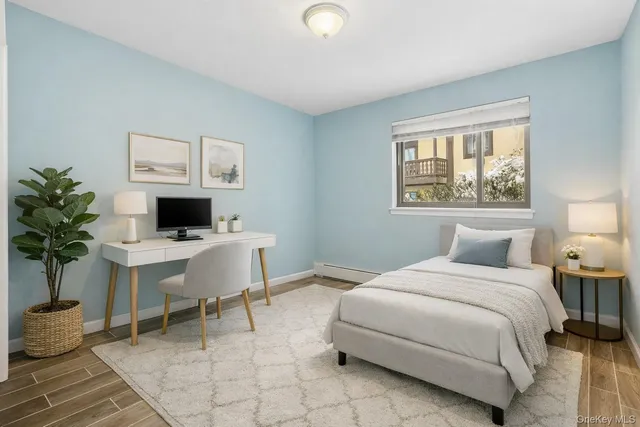 a bedroom with a bed and a potted plant