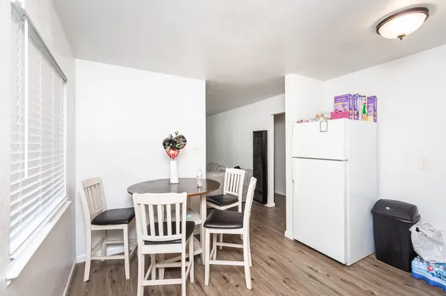 a dining room with furniture and wooden floor